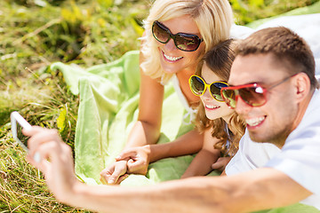 Image showing happy family with camera taking picture