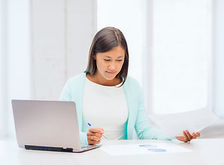 Image showing asian businesswoman with laptop and documents