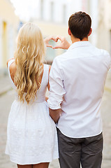 Image showing romantic couple in the city making heart shape