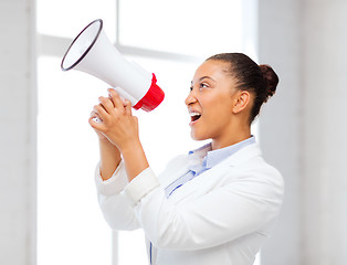 Image showing strict businesswoman shouting in megaphone