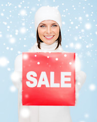 Image showing woman in winter clothes with red sale sign