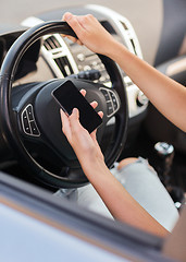 Image showing woman using phone while driving the car