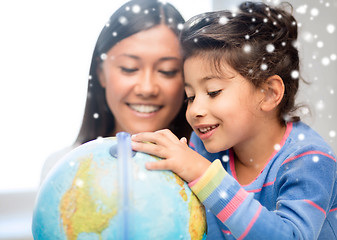 Image showing mother and daughter with globe