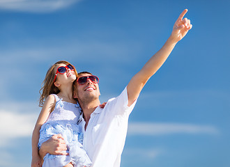 Image showing happy father and child in sunglasses over blue sky