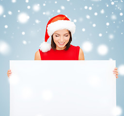 Image showing woman in santa helper hat with blank white board