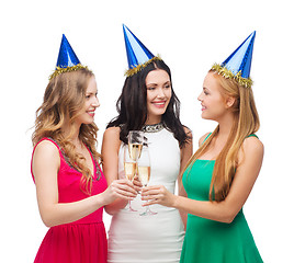 Image showing three women wearing hats with champagne glasses