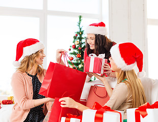 Image showing women in santa helper hats with shopping bags