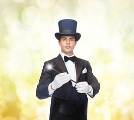 Image showing magician in top hat with magic wand showing trick