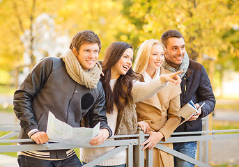 Image showing couples with tourist map in autumn park