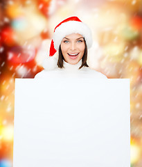 Image showing woman in santa helper hat with blank white board