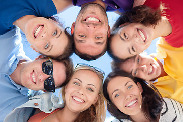 Image showing group of teenagers looking down