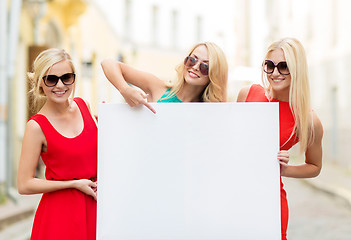 Image showing three happy blonde women with blank white board