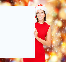 Image showing woman in santa helper hat with blank white board