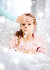 Image showing ill girl child with thermometer and caring mother