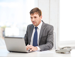 Image showing businessman with laptop computer and documents