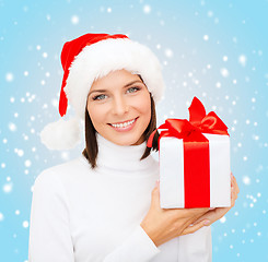 Image showing smiling woman in santa helper hat with gift box