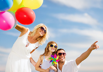 Image showing family with colorful balloons