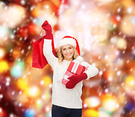 Image showing woman in santa helper hat with shopping bags