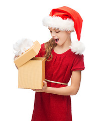 Image showing smiling girl in santa helper hat with gift box