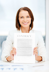 Image showing happy businesswoman holding contract