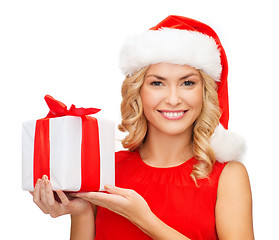 Image showing smiling woman in santa helper hat with gift box