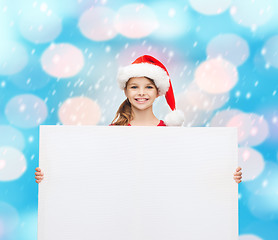 Image showing woman in santa helper hat with blank white board