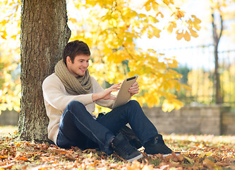 Image showing man with tablet pc in autumn park