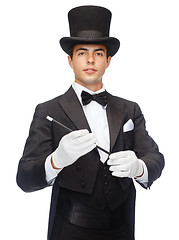 Image showing magician in top hat with magic wand showing trick