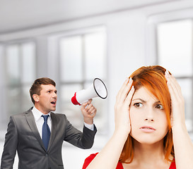 Image showing buisnessman with bullhorn and stressed woman