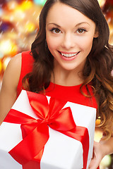 Image showing smiling woman in red dress with gift box