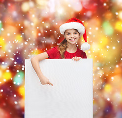 Image showing woman in santa helper hat with blank white board