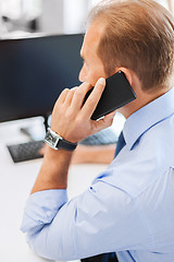 Image showing businessman with smartphone in office