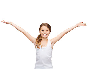 Image showing smiling teenage girl with raised hands