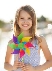 Image showing happy girl with colorful pinwheel toy