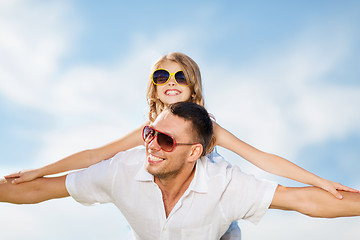 Image showing happy father and child in sunglasses over blue sky