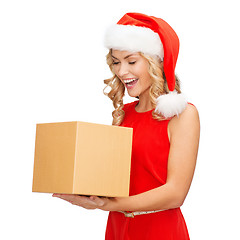 Image showing smiling woman in santa helper hat with gift box