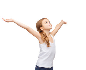 Image showing smiling teenage girl with raised hands