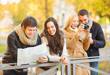 Image showing couples with tourist map and camera in autumn park