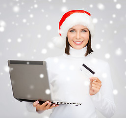 Image showing woman in santa hat with laptop and credit card