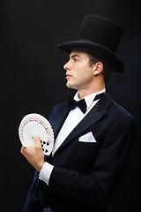 Image showing magician showing trick with playing cards