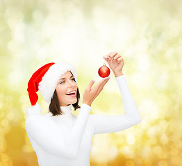 Image showing woman in santa helper hat with christmas ball