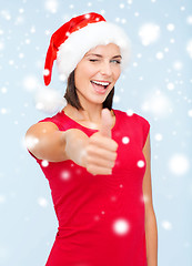 Image showing woman in santa helper hat showing thumbs up