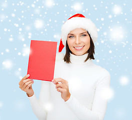 Image showing woman in santa helper hat with blank red card