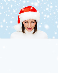 Image showing woman in santa helper hat with blank white board