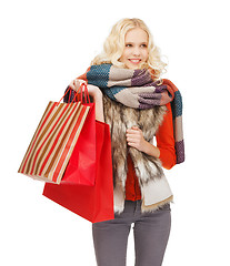 Image showing teenage girl in winter clothes with shopping bags