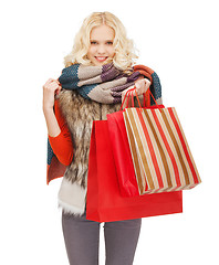 Image showing teenage girl in winter clothes with shopping bags