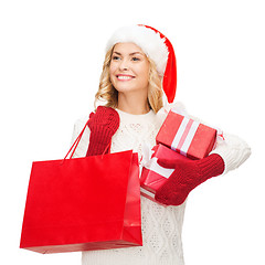 Image showing woman in santa helper hat with shopping bags