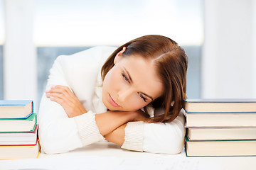 Image showing tired student with books and notes