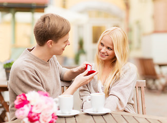 Image showing romantic man proposing to beautiful woman