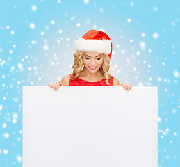 Image showing woman in santa helper hat with blank white board